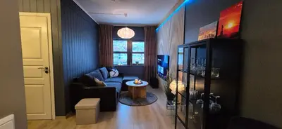a living room with a couch and a table at Moderne cityleilighet Sogndal in Sogndal