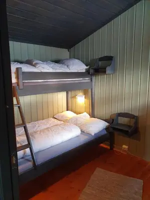 two bunk beds in a room with a ladder at Bjørgebu Camping AS in Mysusæter