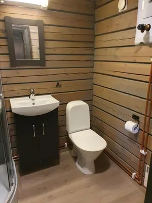 a bathroom with a white toilet and a sink at Bjørgebu Camping AS in Mysusæter