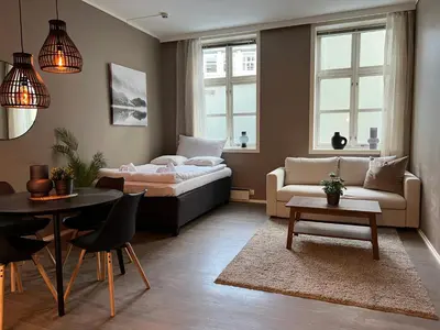 a bedroom with a bed and a table and a couch at Vaskerelven 4 in Bergen