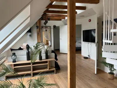 a living room with a couch and a tv at Vaskerelven 4 in Bergen
