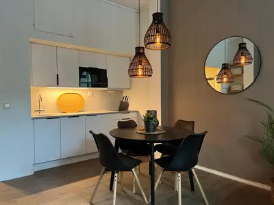 a kitchen and dining room with a table and chairs at Vaskerelven 4 in Bergen