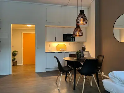 a kitchen and dining room with a table and chairs at Vaskerelven 4 in Bergen