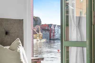 a room with a window with a view of a river at Seaside Apt. Catch Crabs from Your Bedroom Window! in Bergen