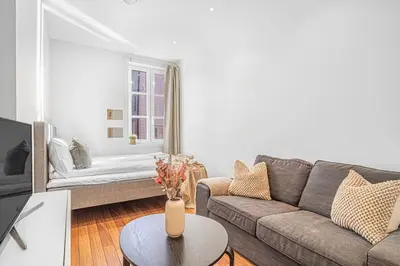a living room with a couch and a table at Seaside Apt. Catch Crabs from Your Bedroom Window! in Bergen