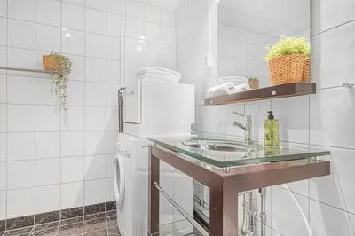 a kitchen with a sink and a counter top at Ocean-view Haven: Take a swim from your window! in Bergen