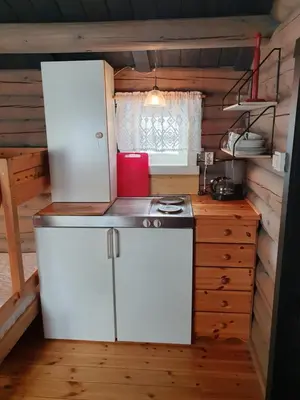 a kitchen with a white refrigerator and a stove at Bjørgebu Camping AS in Mysusæter