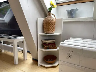 a staircase with a desk and a table with a vase at City View & Central Location in Trondheim