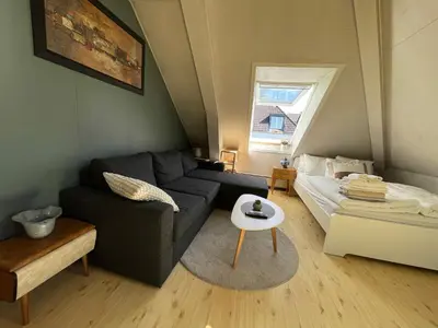 a living room with a couch and a table at City View & Central Location in Trondheim