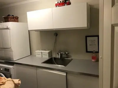 a kitchen counter with a sink and a microwave at Spacious house near city centre - WSC 2025! in Trondheim
