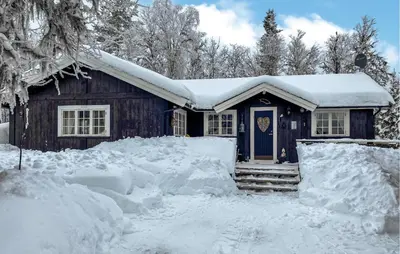 a house with a blue door in the snow at Nice Home In Gol With Kitchen in Golsfjellet