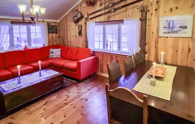 a living room with a red couch and a table at Nice Home In Gol With Kitchen in Golsfjellet