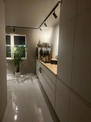 a kitchen with white cabinets and a counter top at Sentral leilighet i Trondheim in Trondheim