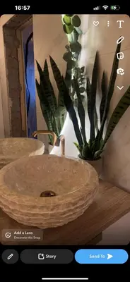 a bathroom with a wooden sink and a potted plant at Sentral leilighet i Trondheim in Trondheim
