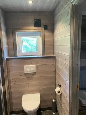 a small bathroom with a toilet and a window at Kvammen in Sæbø