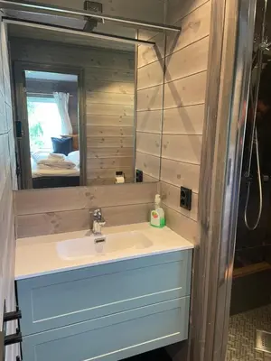 a bathroom with a sink and a mirror at Kvammen in Sæbø