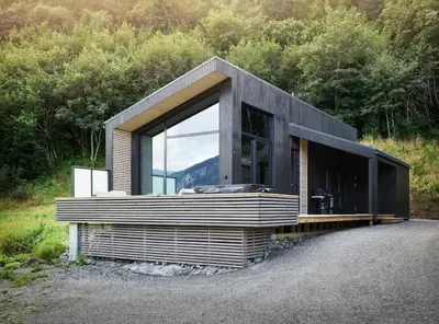a house on a hill with a large window at Koie Deluxe II in Stranda