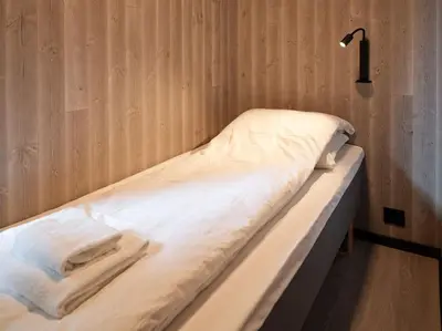 a bed in a room with a light on it at Koie Deluxe II in Stranda