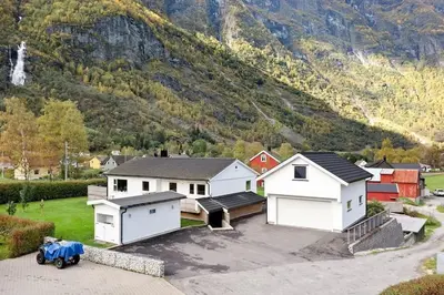 a group of houses in front of a mountain at Fint hus i Flåm in Aurland