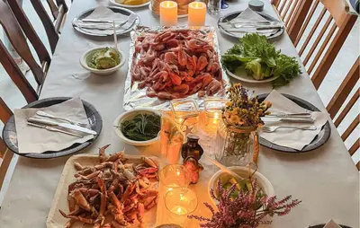 a table with plates of food on a table at 2 Bedroom Cozy Home In Finnås in Grutle