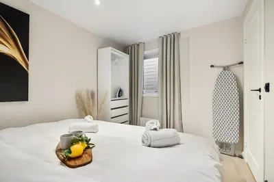 a bedroom with a bed with a basket of fruit on it at King bed - Renovated 2024 - 2BR Behind Bryggen in Bergen