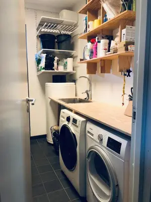 a washing machine in a kitchen with a counter at Cozy Nature Retreat, Danish Design w Jacuzzi option in Sogndal