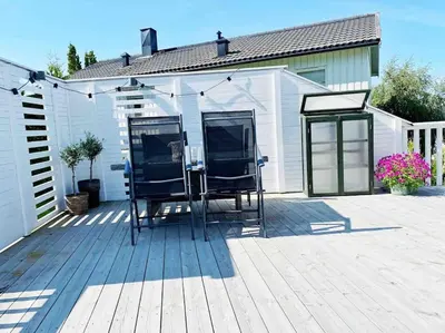a pair of chairs sitting on a patio at Familiebolig med nydelig utsikt in Trondheim
