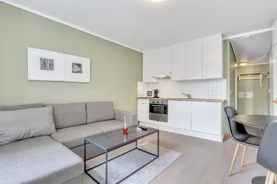 a living room with a couch and a table at Easy Living in Bergen