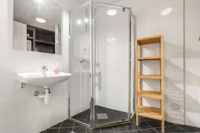 a bathroom with a sink and a shower at Easy Living in Bergen