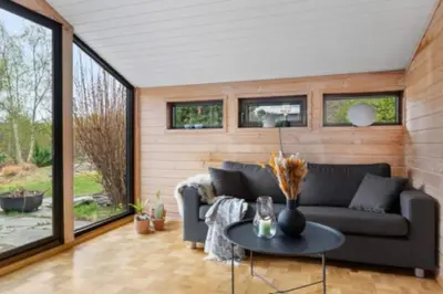 a living room with a couch and a table at Tranquil Haven Villa in Ålesund