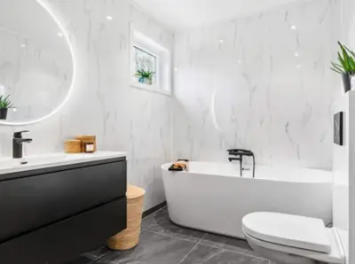 a white bathroom with a tub and a toilet and a sink at Tranquil Haven Villa in Ålesund
