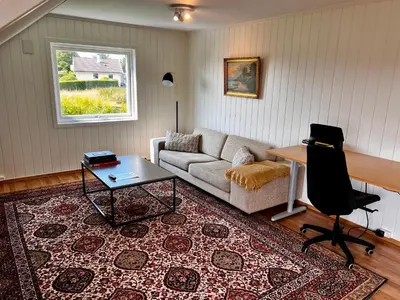 a living room with a couch and a table at Fjord-View Retreat with Free Parking and Fast Internet in Nese