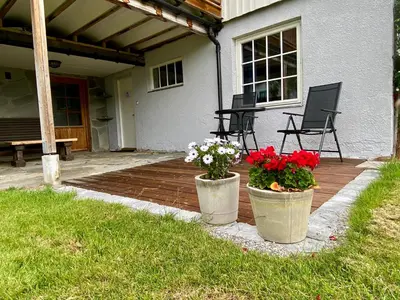 two pots with flowers in them on a patio at Heinåli apartment in Isfjorden