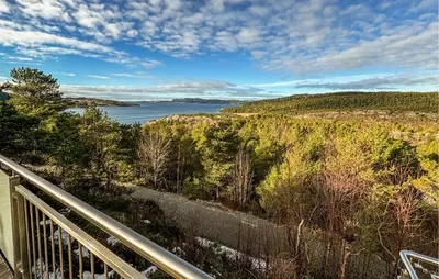a view of a lake from a balcony at Awesome Home In Fevåg With Wifi in Fevåg
