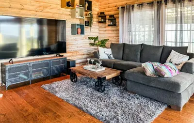 a living room with a couch and a large television at Awesome Home In Fevåg With Wifi in Fevåg