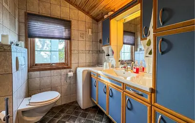 a bathroom with a toilet and a sink at Awesome Home In Fevåg With Wifi in Fevåg