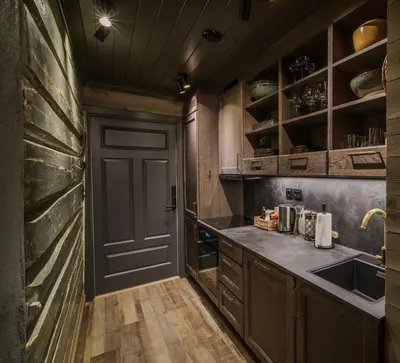 a kitchen with a door and a sink and a counter at Bokhandel'n Gjestehus in Vågåmo