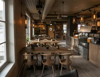 a row of tables and chairs in a restaurant at Bokhandel'n Gjestehus in Vågåmo