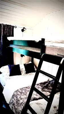 a bedroom with a bunk bed and a bed with appelin at Hytta for 8 personer skiut/inn in Trysil
