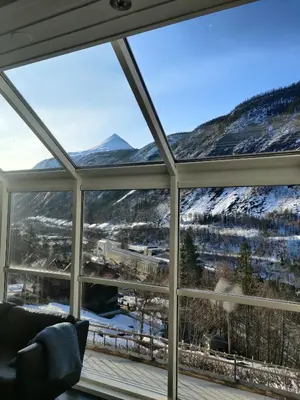 a room with a view of a snowy mountain through a window at Fritt beliggende stor enebolig med høy standard in Rjukan
