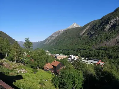 a village in a valley with mountains in the background at Fritt beliggende stor enebolig med høy standard in Rjukan