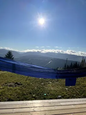 a blue tarp on a fence with the sun in the sky at Apartment with beautiful panoramic view in Skulestadmo