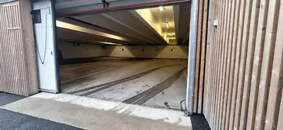 an empty hallway of a building with an open door at Sentral leilighet på Geilo in Geilo