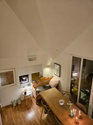 a living room with a table and a couch at Ny og moderne leilighet, midt i byen1 in Trondheim