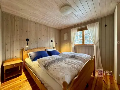 a bedroom with a large bed in a room at Family-friendly cabin at Sjusjøen with ski trails, sauna and fireplace in Ringsaker