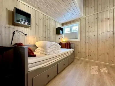 a small room with a bed and a tv at Family-friendly cabin at Sjusjøen with ski trails, sauna and fireplace in Ringsaker
