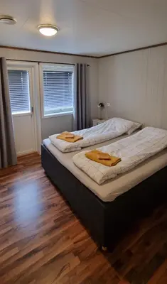 a bedroom with two beds with towels on them at Hus i flott natur in Skjåk