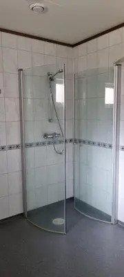 a bathroom with a shower with a glass door at Hus i flott natur in Skjåk