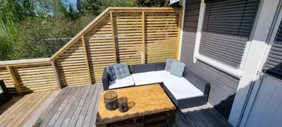 a patio with a bench and a table on a deck at Hus i flott natur in Skjåk