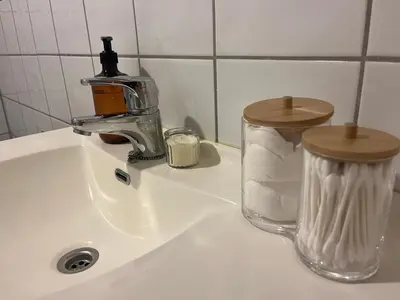 a sink with a faucet and a container of paper towels at Modern and central Apartment - Solsiden Trondheim - Up to 6 people in Trondheim